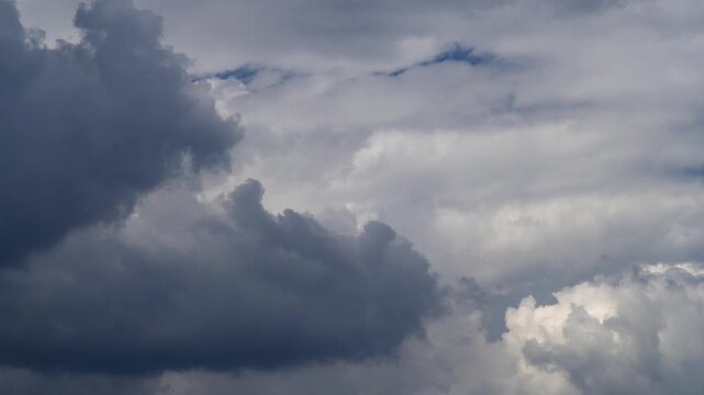 Sky time lapse with moving turbulent clouds on blue sky.