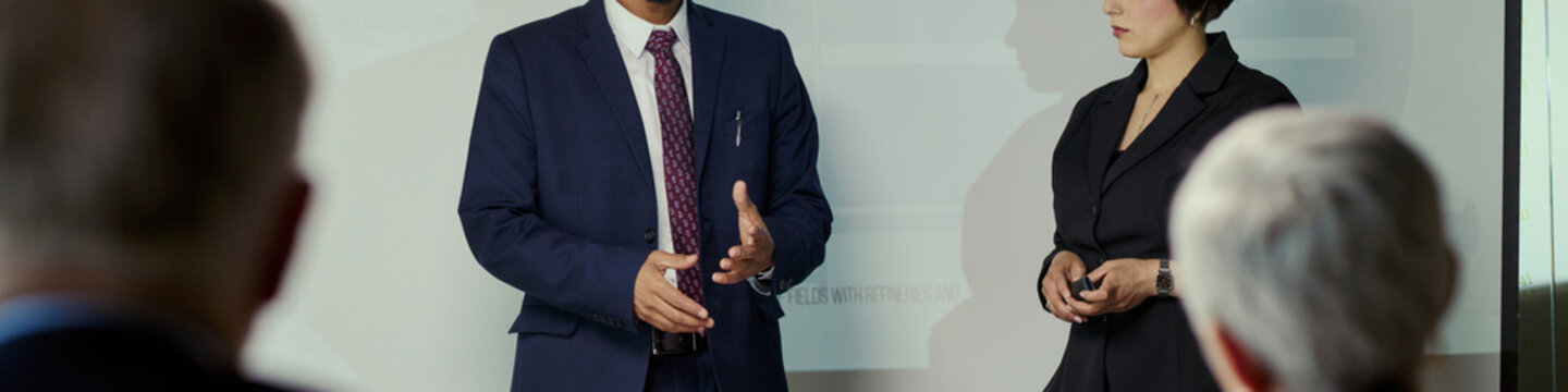 Header of diverse business team discussing oil industry strategy during corporate meeting, presenting data for energy planning and executive decision making. Ideal for energy business marketing
