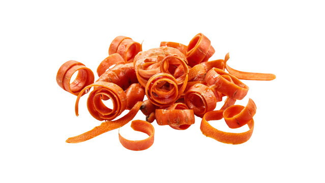 Fresh vibrant orange carrot peels curled into delicate ribbons arranged in a messy pile for healthy cooking preparation photographed in bright light on transparent background