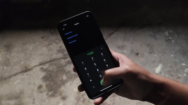 Close Up of Hand Holding Smartphone Running USSD Code Dial MMI Code on Screen