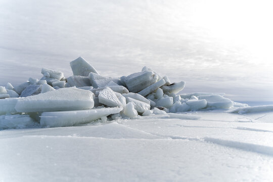 Desolate winter landscape of massive white ice hummocks piled up on a frozen sea