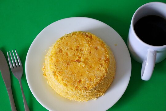 Traditional Brazilian couscous served with a cup of coffee. Northeastern Brazilian breakfast (cuscuz nordestino).