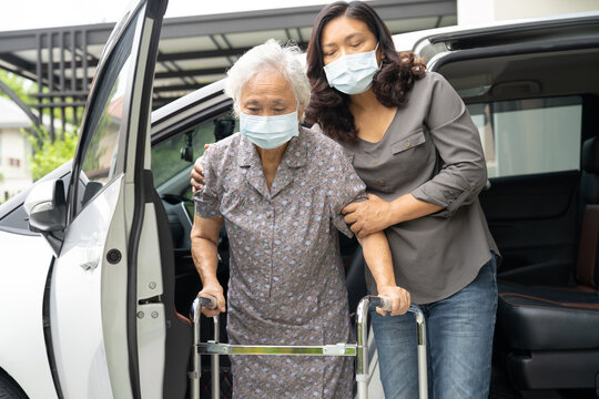 Asian senior woman patient sitting on walker prepare get to her car, healthy strong medical concept.