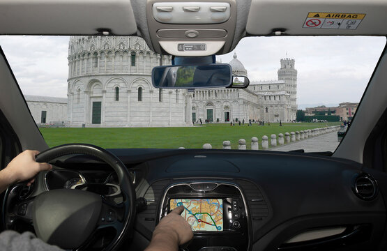 Driving using navigation system in Piazza dei Miracoli, Pisa, Italy