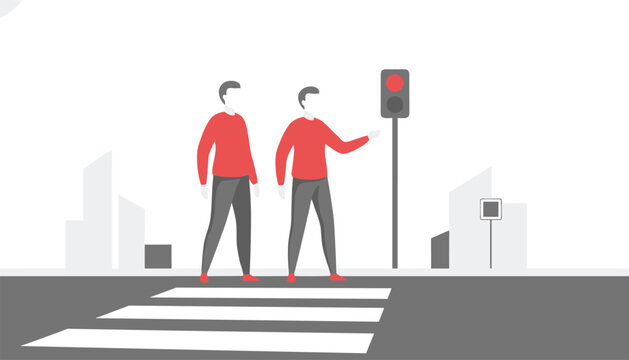 Two people waiting to cross the road at a pedestrian crossing with a red traffic light signal indicating that they should stop and wait safely.