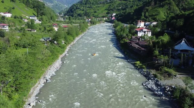 Aerial drone shot of people rafting on foaming river in Firtina Valley, Rize Turkey