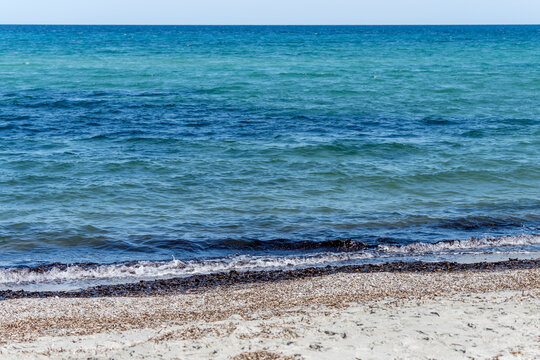 white sand and blue water at Salamaghe cove beach on Mediterranean coast, near Budoni, Italy