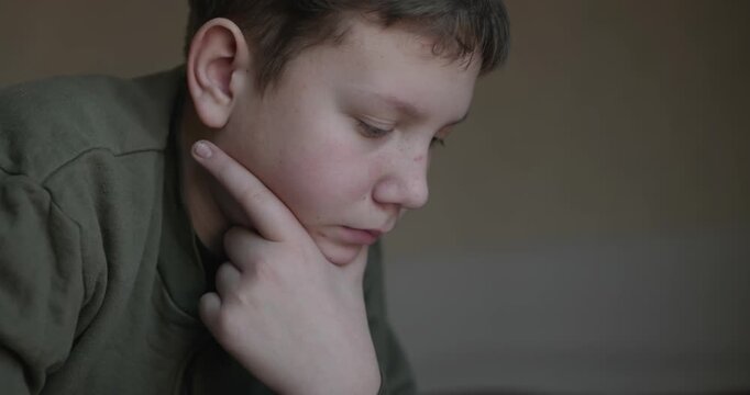Caucasian Boy Kid Read Bible Book Lying on Bed in Bedroom. 4K 10-bit