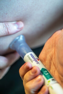 Rio de Janeiro, Brazil - June 25, 2026: Mounjaro pen injection being administered to an individual in a home setting