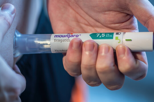 Rio de Janeiro, Brazil - June 25, 2026: Mounjaro pen injection being administered to an individual in a home setting