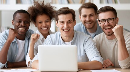 Fototapeta premium Diverse team celebrates success while looking at a laptop screen together