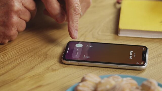Close-up of senior man receiving spam phone call, scam awareness concept