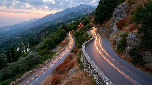 Winding mountain road in pelion creating light trails at dusk