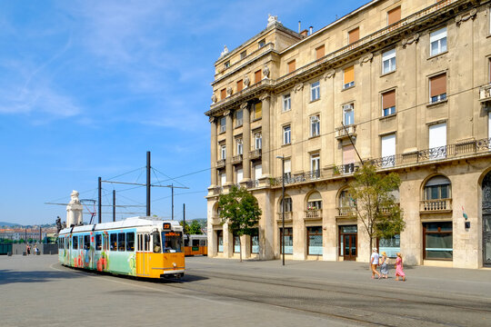 Tram Passing a City Building in Budapest