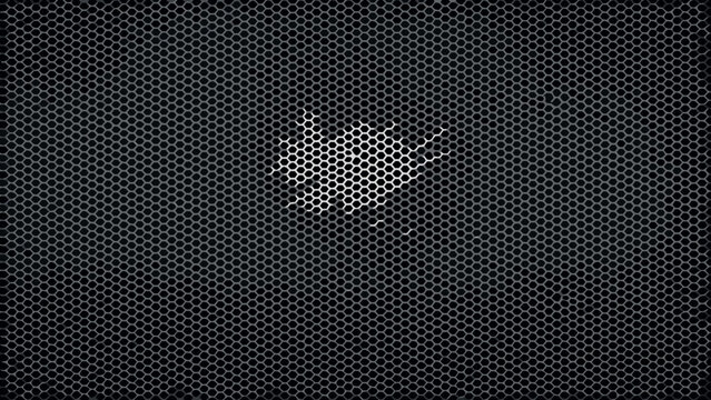 Perforated metal sheet with a bird shaped opening a dark industrial background texture shape silhouette outline grid