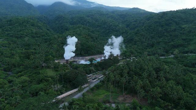 Drone view of Tiwi Geothermal Power Plant with active steam vents in Albay, Philippines. Ideal for clean energy and sustainability concepts.