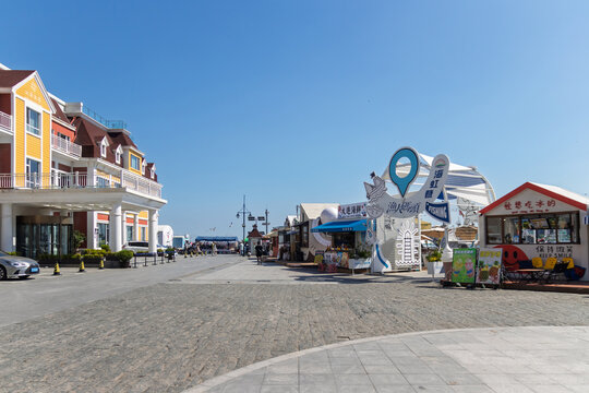 Dalian,China-June 5, 2026:Seaside promenade with shops. Fisherman&rsquo;s Wharf is one of the city&rsquo;s most photogenic seaside spots, where colorful European-style architecture meets an active fishing harbor.