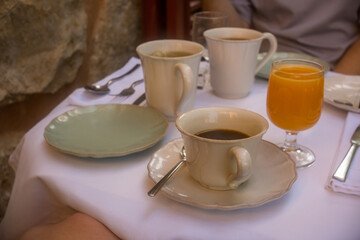 Fototapeta premium Coffee and orange juice on breakfast table