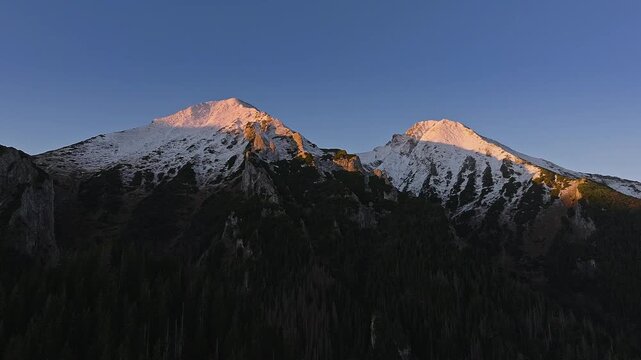 High Tatras, Slovakia - 4K flying away the High Tatras mountains on an autumn morning at sunrise with blue sky and golden Tatras peaks