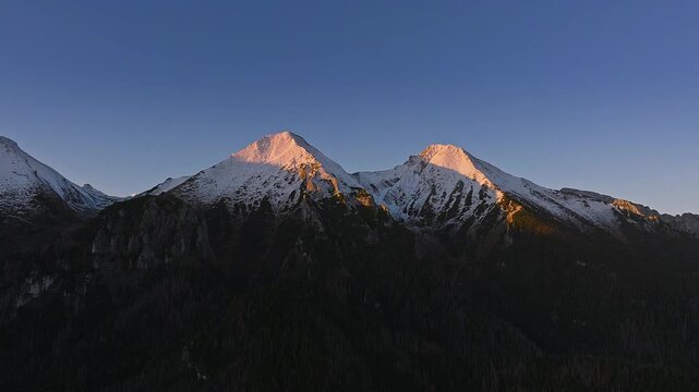 High Tatras, Slovakia - 4K flying away the High Tatras mountains on an autumn morning at sunrise with blue sky and golden Tatras peaks