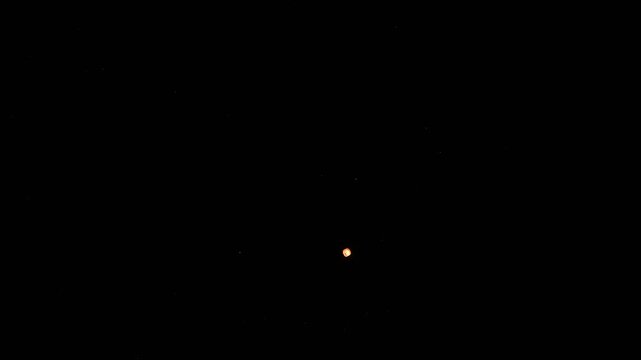 Beautiful bright floating lantern flying solo in the darkness of night