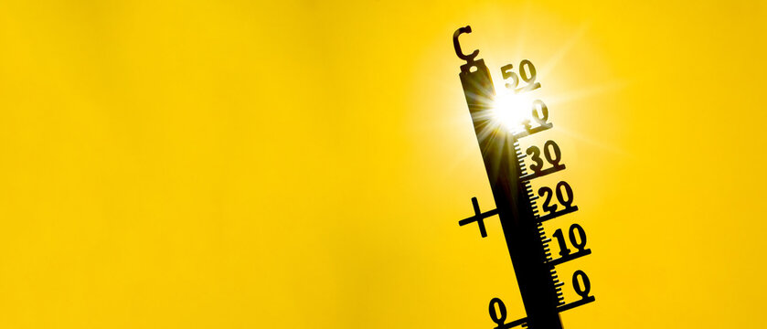 Hot weather, global climate change concept - Heat wave / Summer heat temperature celsius background banner long - Thermometer yellow orange sky and sun rays