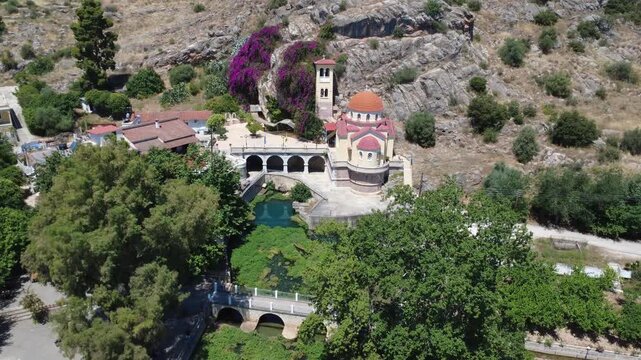 Aerial view of church, stone bridge and lily pond at mountain base