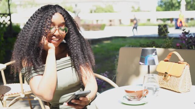Young woman using mobile phoen in a cafe outdoor