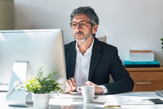 Concentrated elegant businessman working on a computer in the office