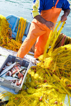 Yellow Fishing Net with Fisherman at Harbor