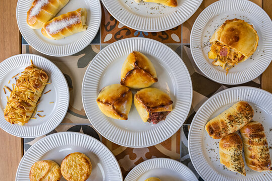 Brazilian salgados - Savory Pastries served on multiple plates