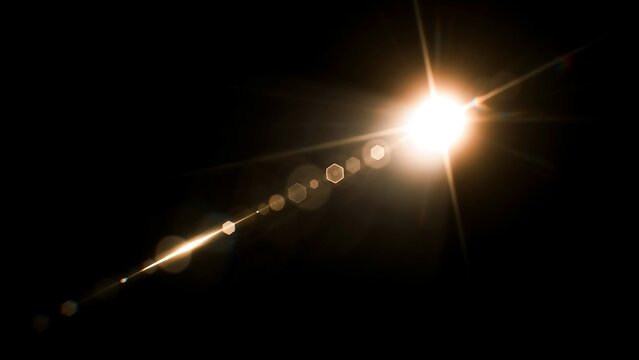 Bright lens flare with starburst and hexagonal bokeh effect on black background, warm golden light reflection