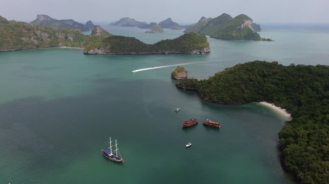 Aerial footage of tourist boats sailing through the beautiful ang thong national marine park