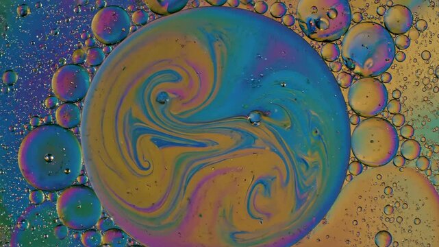 Exploring colors and bubbles in oil and water mixture at home with close-up shots