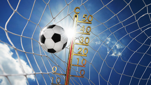  Soccer ball in soccer goal net, isolated on sunny blue sky background. hydration breaks by  heat wave concepte.