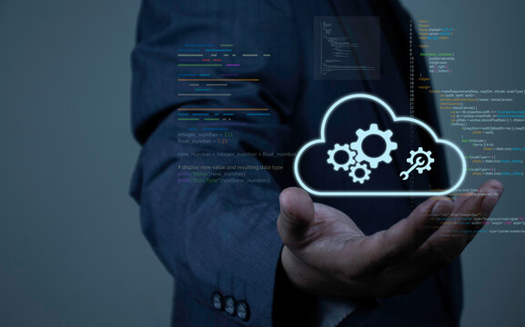 Businessman showing open hand with virtual cloud native icon, gears, wrench, and programming source code. Concept of cloud computing architecture, microservices, and software development.