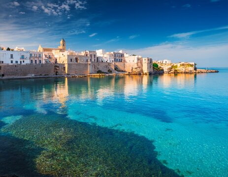 ancient buildings of otranto town reflected in the calm waters of adriatic sea sunny morning scene of apulia italy europe picturesque summer view of alimini beach in otranto resort