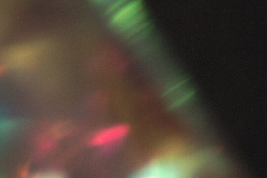 light leak overlay effect with dust and blur colorful light leaks,retro noisy film texture light leak flare on black background,abstract background with colorful light,grunge old film burn