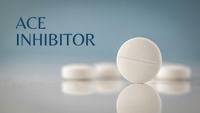 White pills on reflective surface with blue background and ACE inhibitor text