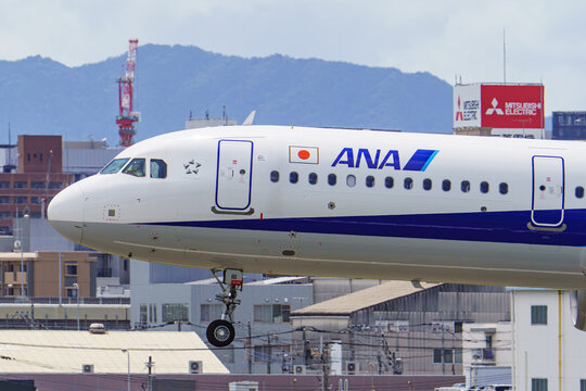 An All Nippon Airways (ANA) Airbus A321 taxiing at Fukuoka Airport with the cityscape behind on August 8, 2020 in Fukuoka, Japan.
