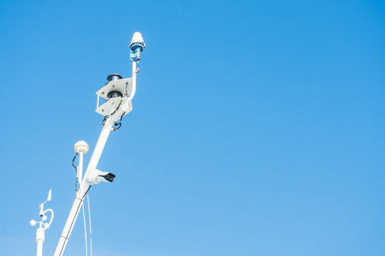 White Marine Mast with Navigation Lights and Surveillance CCTV Camera Recording, The Concept of Maritime Security