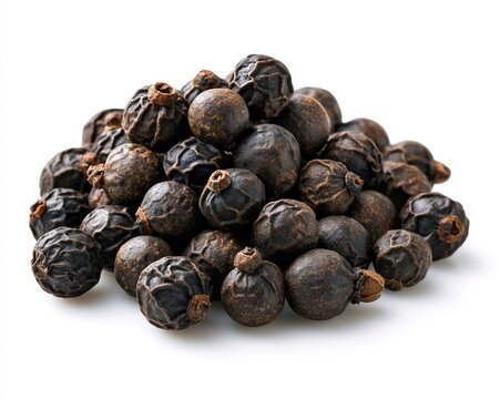 Black pepper pile, close-up view of dark peppercorns against white background.