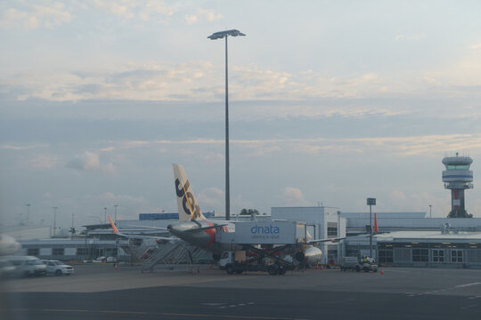 A Jetstar Airbus A320 and the control tower at Cairns Airport on November 3, 2024 in Cairns,Queensland,Australia,travel,tourism,Far North Queensland.