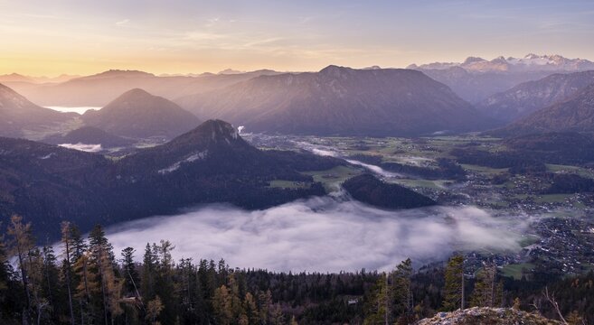 View from Mount Loser to Lake Altaussee, Altaussee, Bad Aussee, Tressenstein, Zinken, Dachstein mountains. Wafts of mist over the lake. In the morning at sunrise. Blue sky. Autumn. Altaussee, Bad Aussee, Ausseer Land, Totes Gebirge, Styria, Upper Austria, Austria