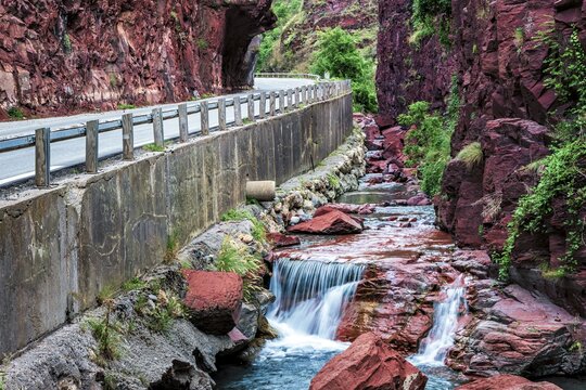 Road through canyon Gorges du Cians with its red rocks, D&eacute;partement Alpes Maritimes, French Maritime Alps, France