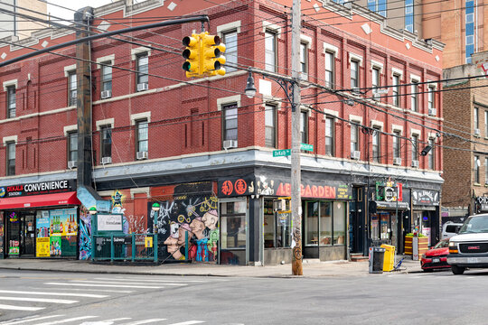 The bohemian neighborhood of Bushwick Brooklyn New York featuring traditional red brick buildings graffiti murals and local shops.