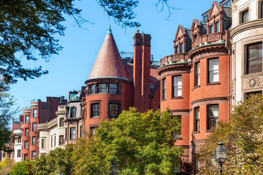 Elegant traditional residential houses and brownstones situated along the tree lined promenade of Commonwealth Avenue Mall in Back Bay Boston.