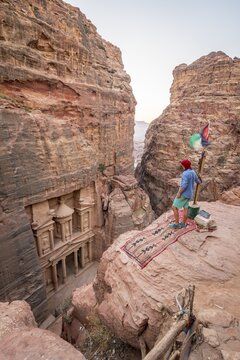 Man, tourist looks from above into the gorge Siq, Pharaoh's treasure house beaten into rock, facade of the treasure house Al-Khazneh, Khazne Faraun, mausoleum in the Nabataean city Petra, near Wadi Musa, Jordan
