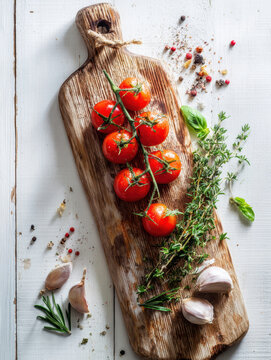 Fresh Cherry Tomatoes with Herbs and Spices on Rustic Wooden Board .AI Generative