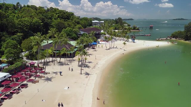 Sentosa Island beach aerial shot showing coastline, sandy shore, and relaxing vacation atmosphere